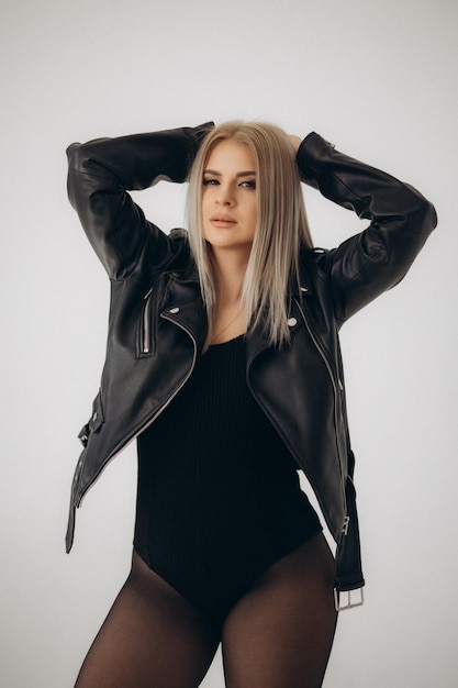 A woman wearing a black leather jacket with the word love on it