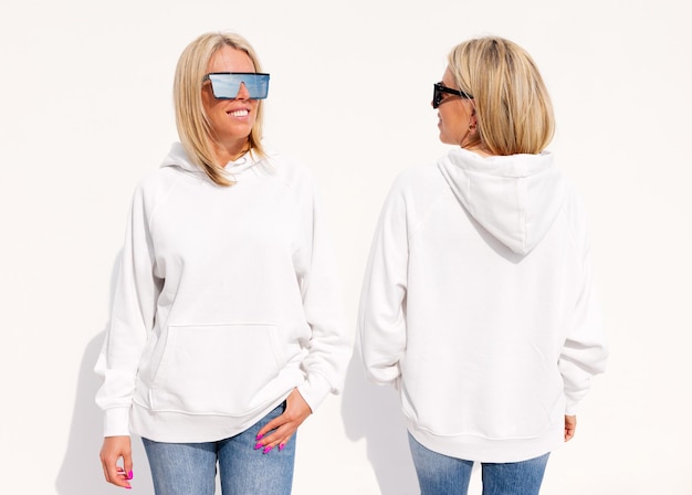 Woman wearing blank white hoody front and back view mockup for\
hoodie sweatshirt design