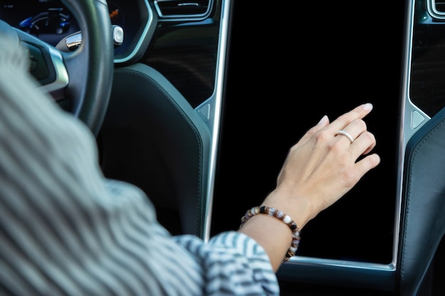 Woman wearing bracelet. Close up of woman wearing bracelet using navigation in car while driving