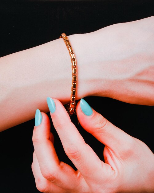 A woman wearing a bracelet with a bracelet on it and a bracelet on her wrist.