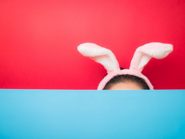 Woman wearing bunny ears headband during Easter.