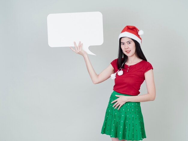 Woman wearing christmas hat showing placard empty