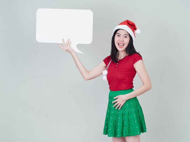 Woman wearing christmas hat showing placard empty