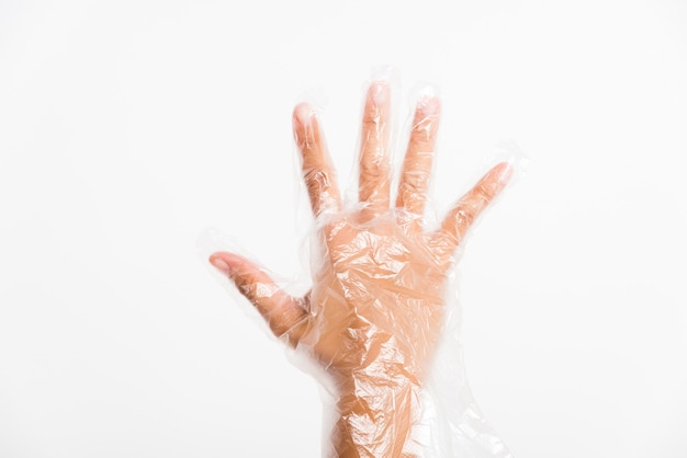 Woman wearing a disposable transparent plastic glove