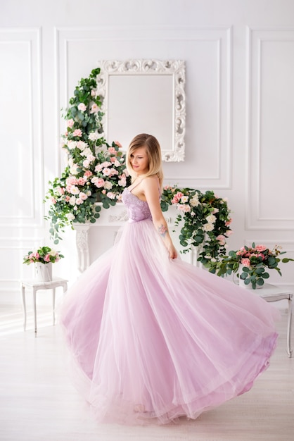 Woman wearing an elegant dress posing in a studio