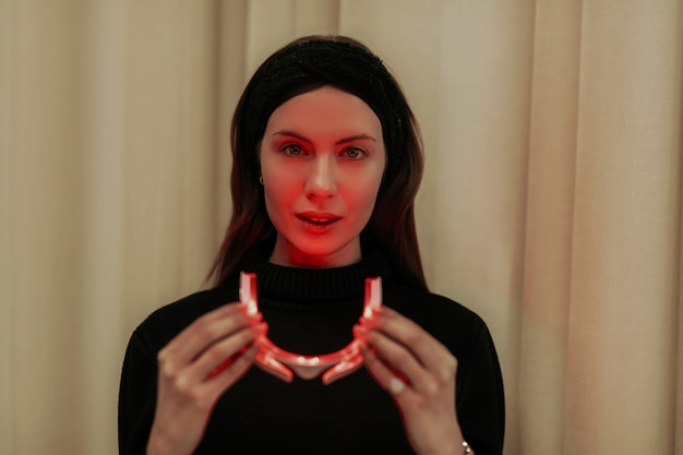 Woman wearing face beauty LED glasses.