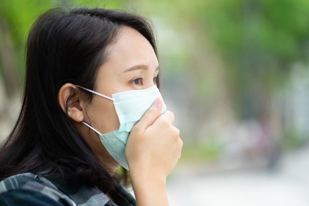 Woman wearing face mask protect filter against air pollution (PM2.5) or wear N95