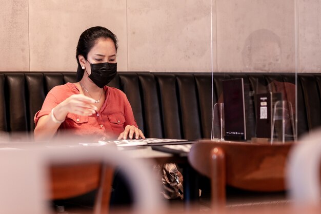 Woman wearing face mask at restaurant