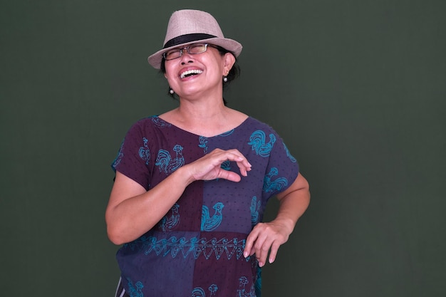 A woman wearing a hat dancing to the music