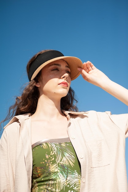 A woman wearing a hat and a shirt that says'i'm a lady '