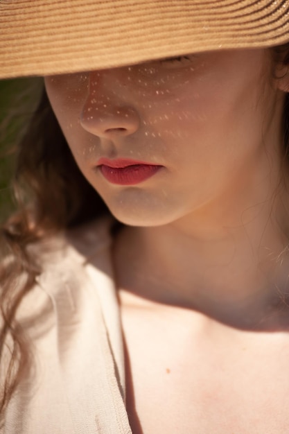 A woman wearing a hat and a straw hat