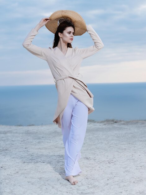 Woman wearing hat while standing on beach