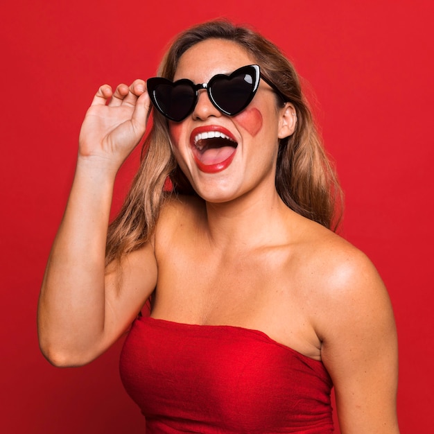 Woman wearing heart shaped sunglasses