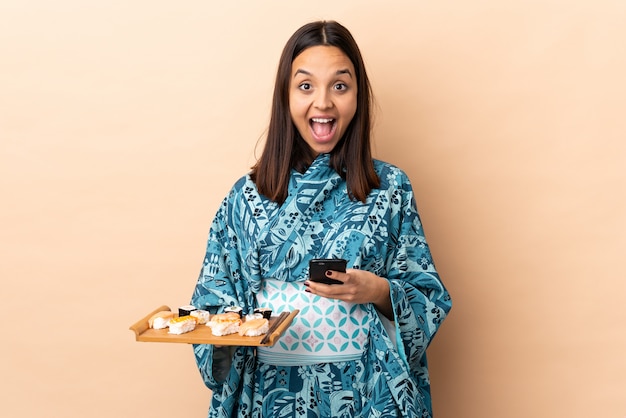 Woman wearing kimono and holding sushi