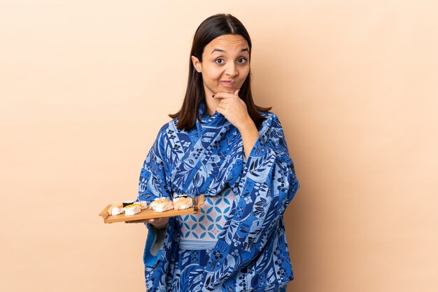 Woman wearing kimono and holding sushi