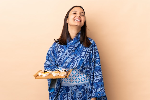 Woman wearing kimono and holding sushi