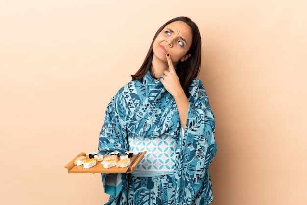 Woman wearing kimono and holding sushi