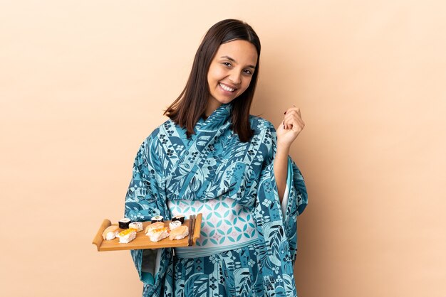 Woman wearing kimono and holding sushi