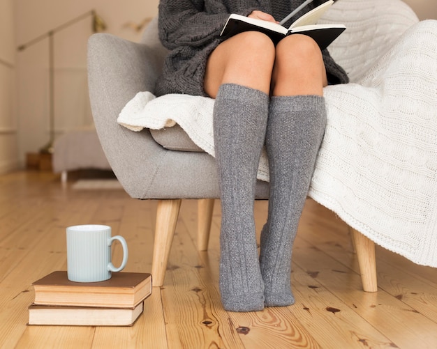 Woman wearing knee socks sitting in armchair