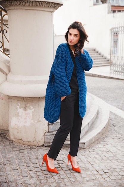 Woman wearing knitted colorful coat outdoor