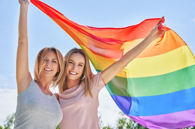 Woman wearing lgbt flag outdoor. High quality photo