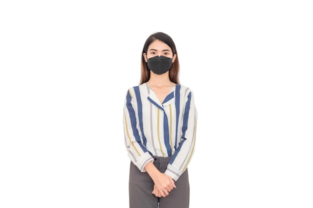 A woman wearing a long-sleeved shirt and a black face mask against a white background.