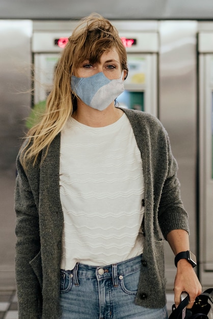 Woman wearing a mask while waiting for the train during the coronavirus pandemic