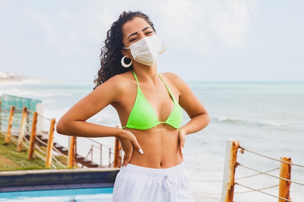 Woman wearing medical mask at beach new normal rules web banner Life after pandemic obligatory use of face mask in public spaces copy space