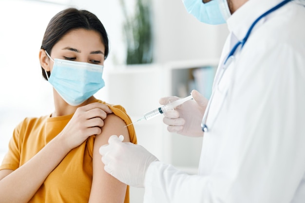 Woman wearing a medical mask at the doctor39s appointment covid19 vaccination epidemic