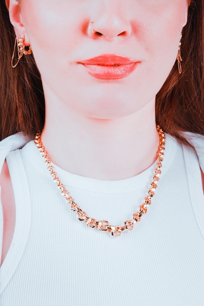 A woman wearing a necklace that says'gold'on it