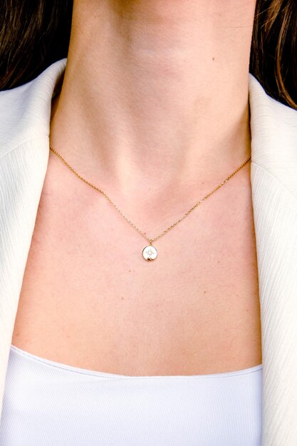 a woman wearing a necklace that says pearl on it