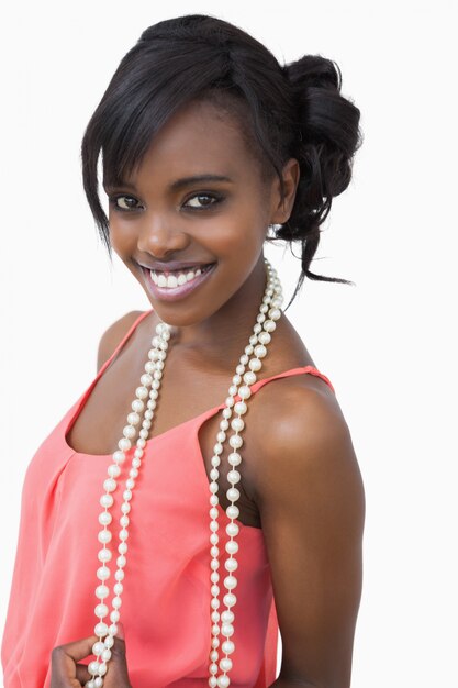 Woman wearing pink dress and pearls