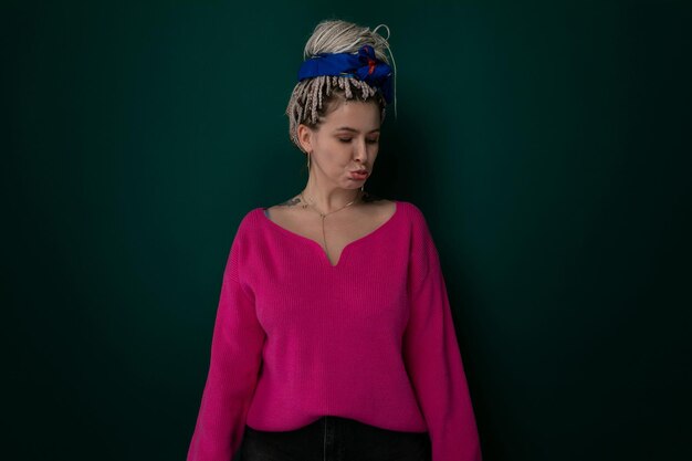 Woman wearing pink sweater and blue headband