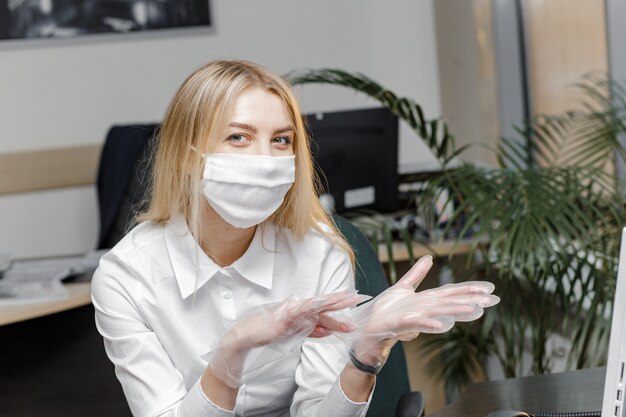 Donna che indossa una maschera protettiva e indossa guanti.