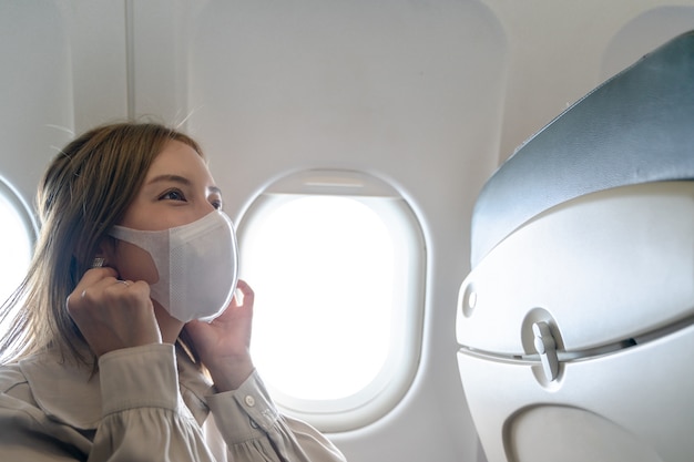 Woman wearing protective masks in airplane