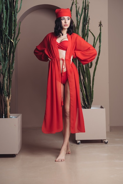 Woman wearing red beach tunic