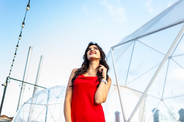 Woman wearing red dress outdoor summer portrait