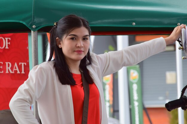 Woman wearing red shirt on Chinese New Year's Eve Captured on April 2 2022 in Rayong Thailand