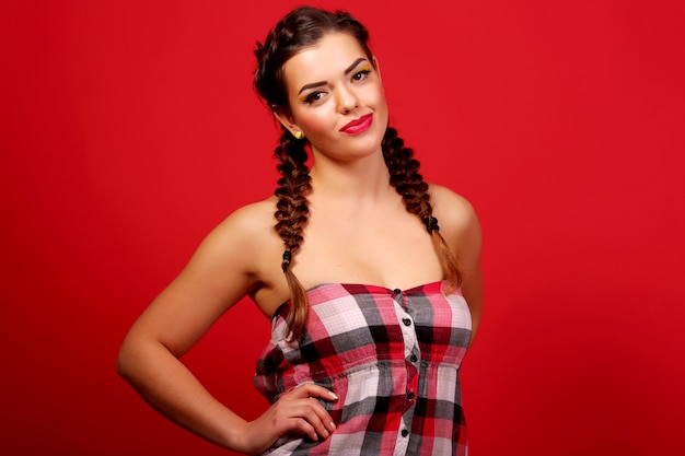 Woman wearing red sweater against red wall