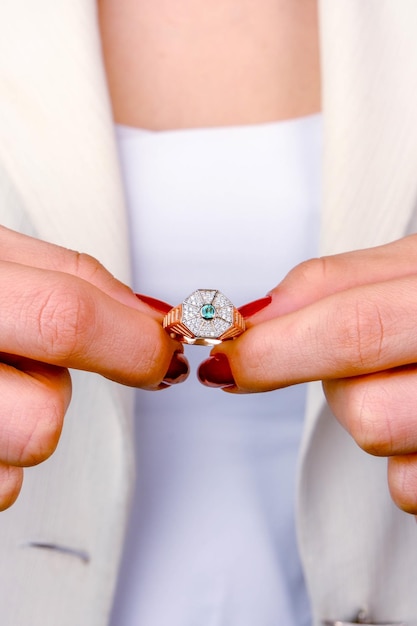 a woman wearing a ring that says  engagement