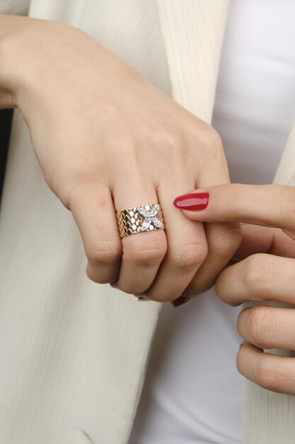 a woman wearing a ring that says  new  on it