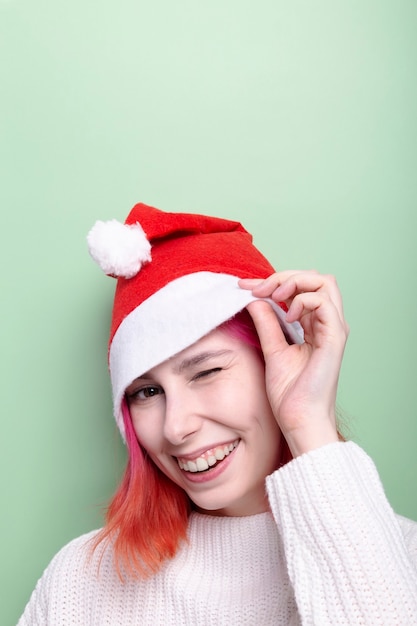 Woman in wearing santa hat smiles