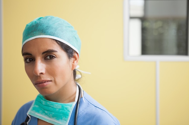 Woman wearing scrubs in hospital room