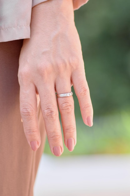 A woman wearing a silver ring with a ring on it