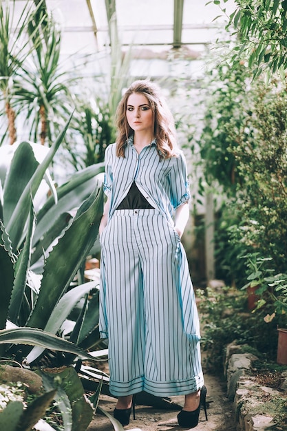 Woman wearing a suit in a botanical garden