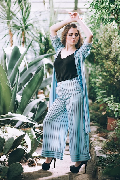 Woman wearing a suit in a botanical garden