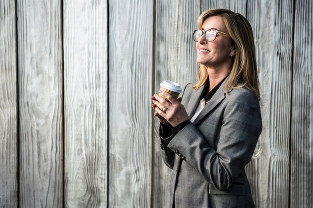 Woman wearing a suit holding a cup of tea