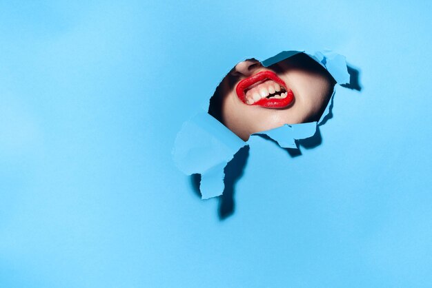 Woman wearing sunglasses against blue background