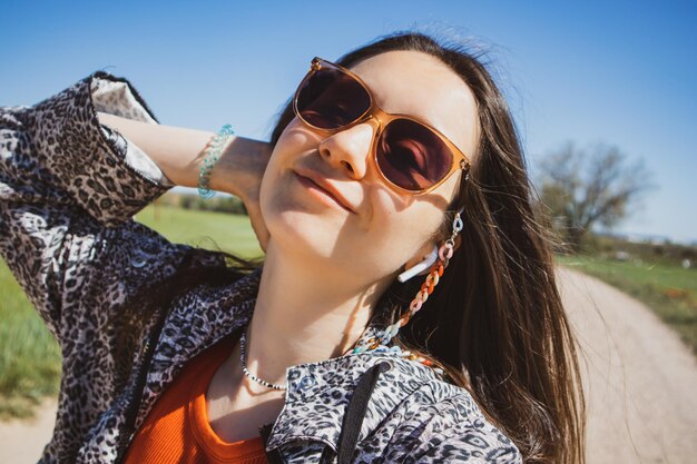 A woman wearing sunglasses and a shirt that says'sun glasses '