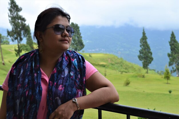 Woman wearing sunglasses while looking away in park